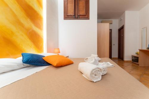 a bedroom with a bed with towels on it at "L'Oasi di Favignana" Room and Charme in Favignana