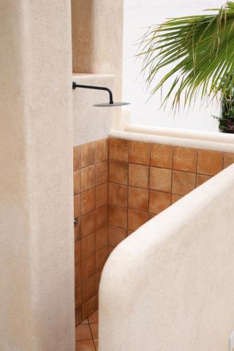 a bathroom with a shower with a tiled floor at Casa Bel - Apartment 5 in Miami Platja