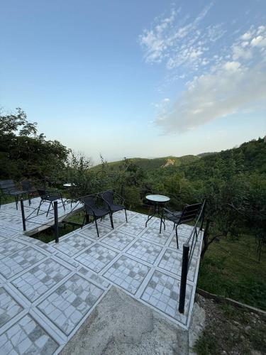 a patio with chairs and a table on top at Green House მწვანე სახლი in Sighnaghi