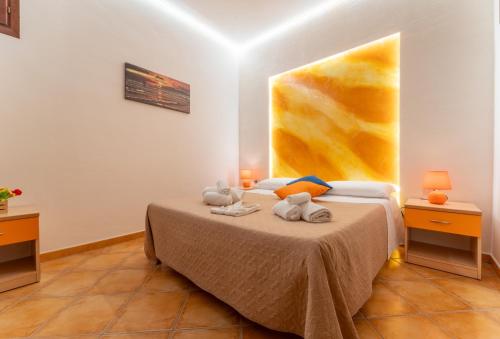 a bedroom with a bed with two stuffed animals on it at "L'Oasi di Favignana" Room and Charme in Favignana