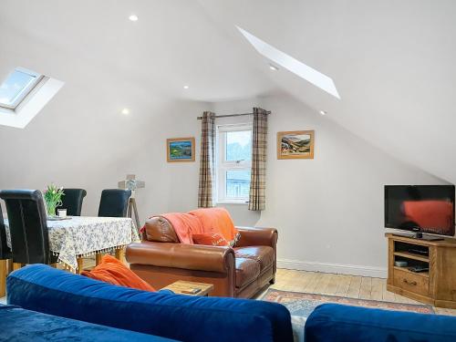 a living room with a couch and a table at Bankfield Barn in Tideswell