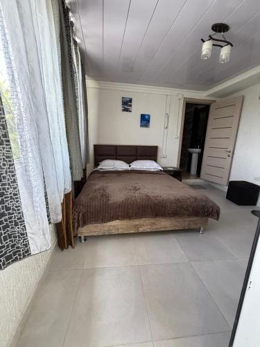 a bedroom with a large bed in a room at Green House მწვანე სახლი in Sighnaghi