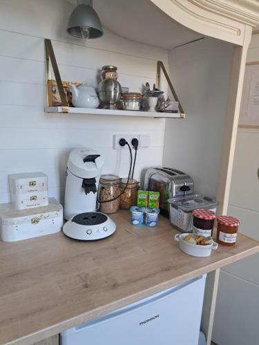 a kitchen counter with food and appliances on it at La Maison du Canal - Homps - Le Sweet in Homps