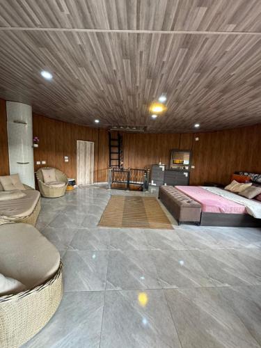 a bedroom with two beds and a wooden ceiling at Neverland Resort مزرعة نيفرلاند in Irbid