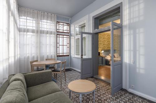 a living room with a couch and a table at Roze Boutique Apartments in Liepāja