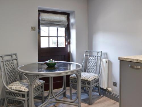 a dining room table and chairs with a bowl on it at The Milking Parlour - Uk30866 in St Bees