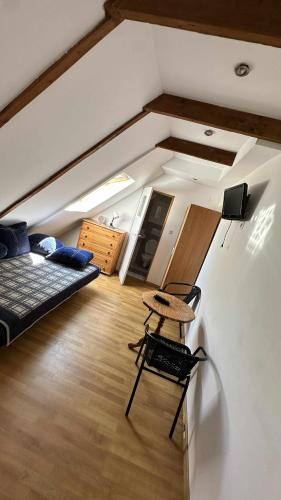 a room with a bed and a chair in a room at na rogu in Pobierowo