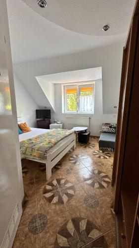 a bedroom with a large bed and a window at na rogu in Pobierowo