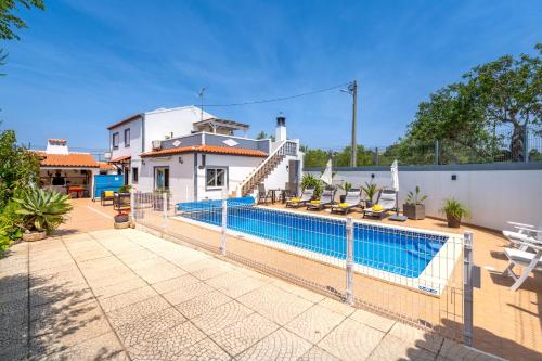 a swimming pool in front of a house at Vila da Encosta - Private - Heated swimming pool - By bedzy in Albufeira
