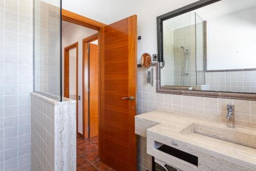 a bathroom with a sink and a mirror at Villa Roselles in Lloret de Mar