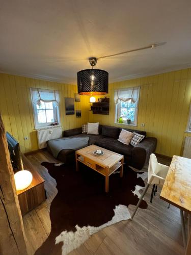 a living room with a couch and a table at Ferienwohnungen Carlsfeld in Eibenstock