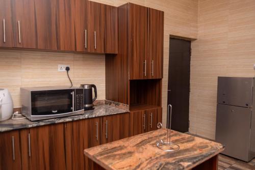 a kitchen with a counter with a microwave and a refrigerator at Marchforte Home in Jahi