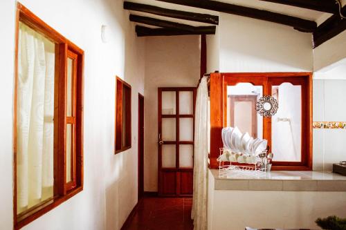 a room with a table and chairs and a window at Apartahotel Casa de Angel in Villa de Leyva