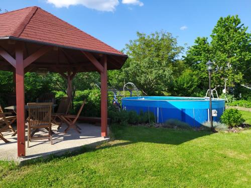 a gazebo with a pool in a yard at Penzion Milná 38 in Milná