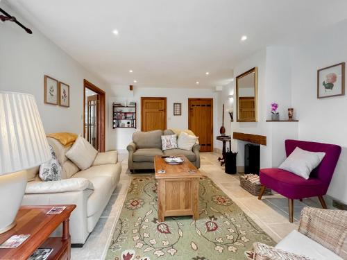 a living room with a couch and a table at Copper Cottage in Atworth