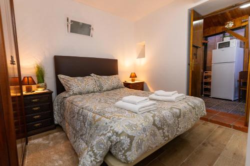 a bedroom with a bed with towels on it at Casa Fernandes by Mth in Ribeira Brava