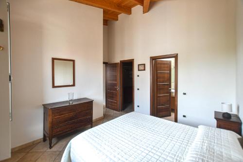 a bedroom with a bed and a dresser and a mirror at Casa Giorgina in Costa Vescovato