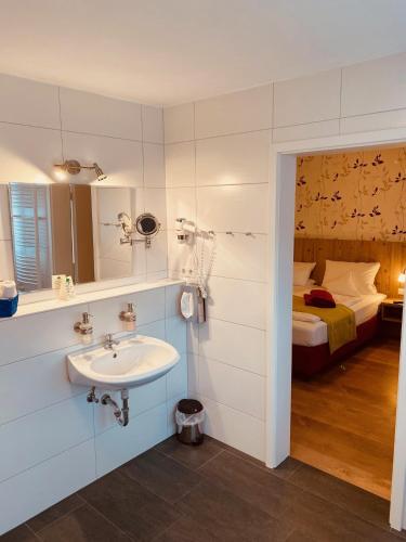 a bathroom with a sink and a bed at Zum Hirsch in Schwäbisch Hall