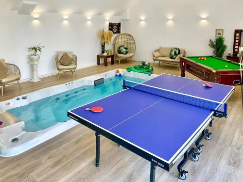 a living room with a ping pong table and a pool at Island Seaview Villa in Rothesay