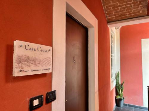 a door to a house with a sign on it at Casa Crova in Nizza Monferrato