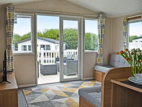 a living room with sliding glass doors at Ocean Edge in Heysham