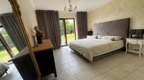a bedroom with a bed and a large window at Belle maison familiale de Kerscaven in Penmarcʼh