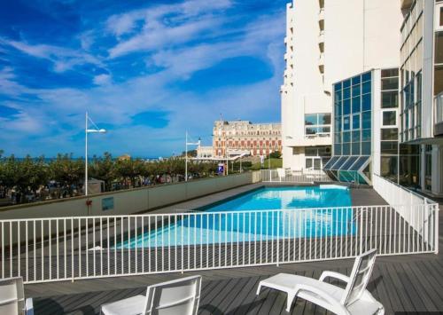 a swimming pool on the balcony of a building at Elegant studio, 2-4 people, WiFi, pool, parking in Biarritz