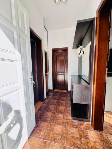a hallway with a kitchen with a stove and a door at Villa RELAX Miševići in Sarajevo