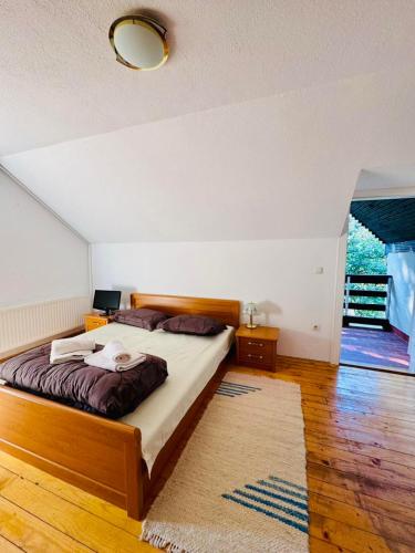 a bedroom with a large bed and a rug at Villa RELAX Miševići in Sarajevo