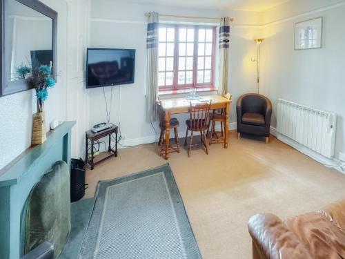 a living room with a couch and a table at Latrigg View - Uk45177 in Threlkeld