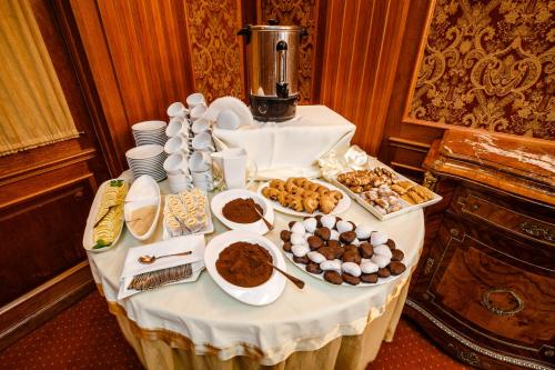 a table with many different types of food on it at Spa Hotel Gloria in Przemyśl