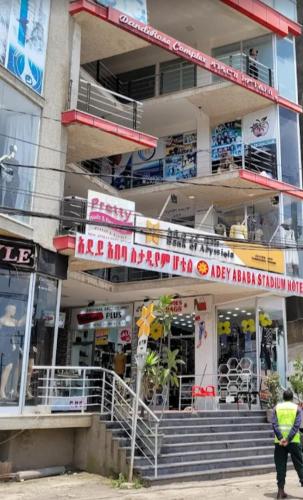 a man walking in front of a building at Adey Ababa Stadium Hotel in Addis Ababa