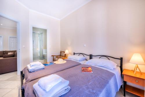a bedroom with two beds with towels on them at Villa Angela in Ágios Matthaíos