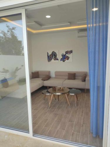 a living room with a couch and a table at Ashyana - Charming Villa in a quiet & peaceful area in Mezraya