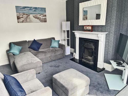 a living room with a couch and a fireplace at Rutland Retreat in Filey