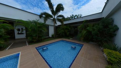 a swimming pool in the yard of a house at Casa Campestre Ocarros in Villavicencio
