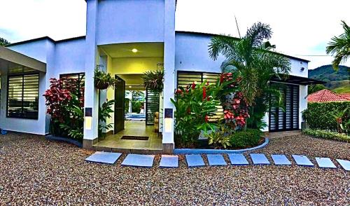a blue house with plants in front of it at Casa Campestre Ocarros in Villavicencio