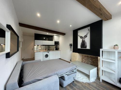 une chambre avec un grand lit et une cuisine dans l'établissement Appartement charmant hyper centre, à Orléans