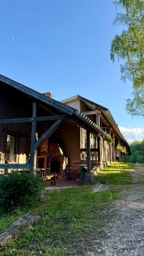 an old barn with a dog sitting inside of it at Eha Farmstay in Rõuge