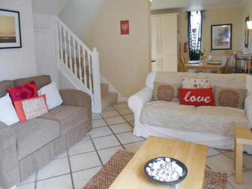 a living room with two couches and a table at Bellagio in Padstow