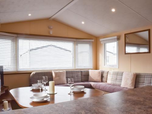 a living room with a couch and a table at Stay And Sea in Heysham