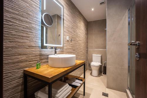 a bathroom with a sink and a toilet at Aethon Airport Project-FREE SHUTTLE by GK Properties in Markopoulo