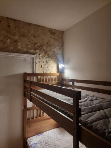 a bedroom with a bunk bed in a room at Péchaud in Lalinde