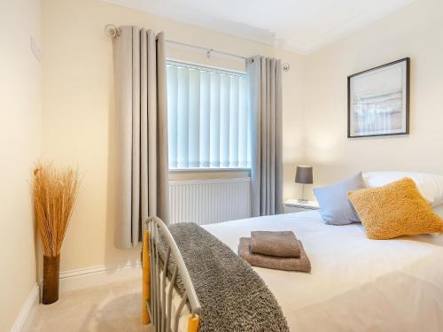 a bedroom with a bed and a window at Delcroft in Drybrook