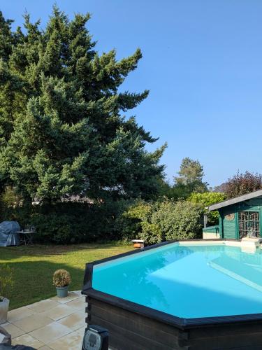 une grande piscine bleue dans une cour dans l'établissement Maison Du cerf - proche du circuit et du golf des 24H, à Mulsanne