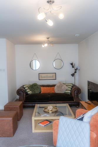a living room with a couch and a coffee table at Elegant Retreat Carnoustie in Angus
