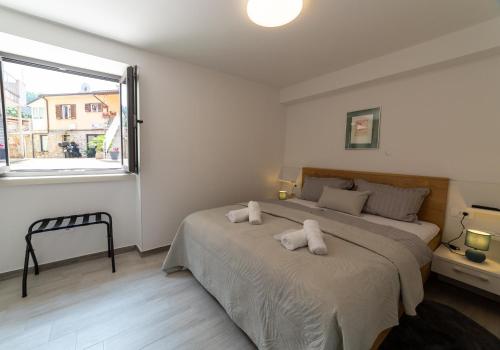 a bedroom with two beds with white towels on them at Apartman Zvane in Pazin