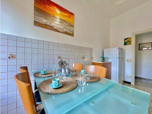 a blue table with chairs and glasses on it at Florentine Castle Apartment in Castelfiorentino