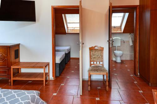 a room with a bedroom with a bed and a toilet at PSZCZÓŁKA in Białogóra