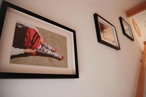 a framed picture of a woman wearing shoes on a wall at Apartamento Rio Irati in Aoiz